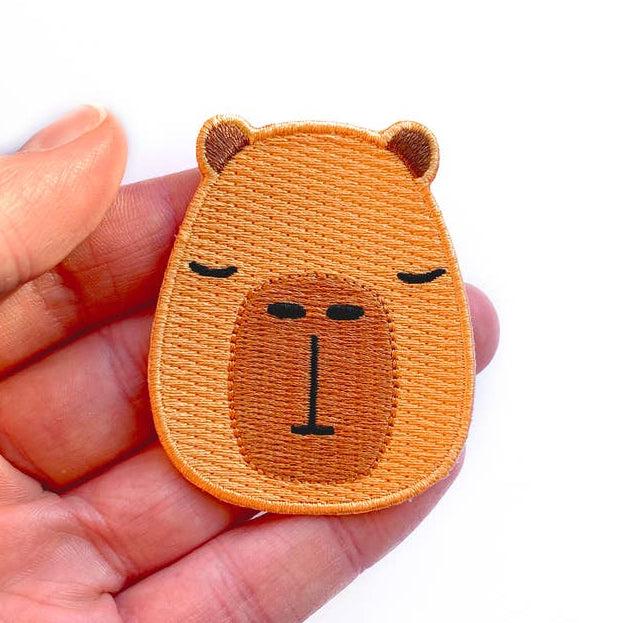 
                      
                        Tom Hardwick Capybara Head, Woven Iron-on Patch
                      
                    