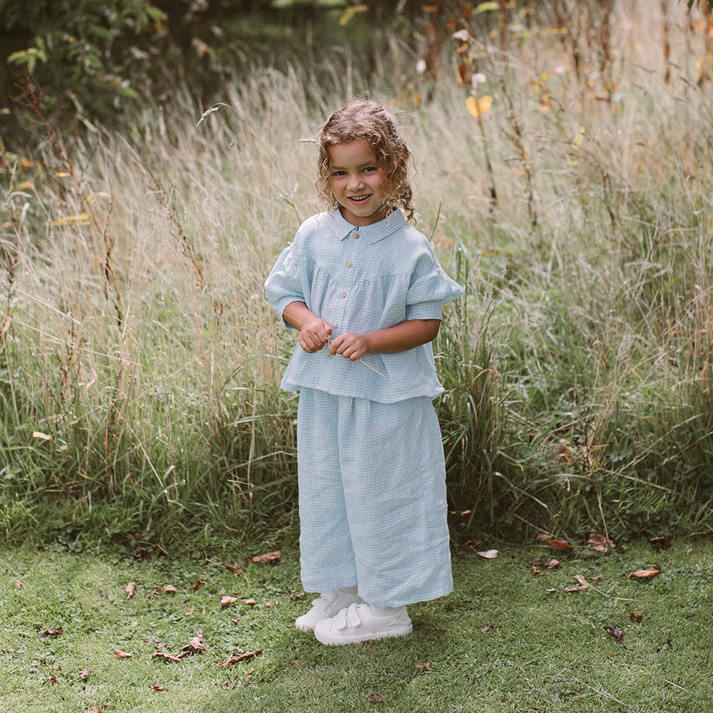 
                      
                        Nellie Quats Duck Duck Goose Blouse - Baby Blue & Milk Mini Check Linen
                      
                    